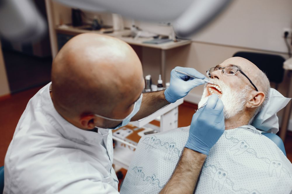 a old man is getting dental treatment
